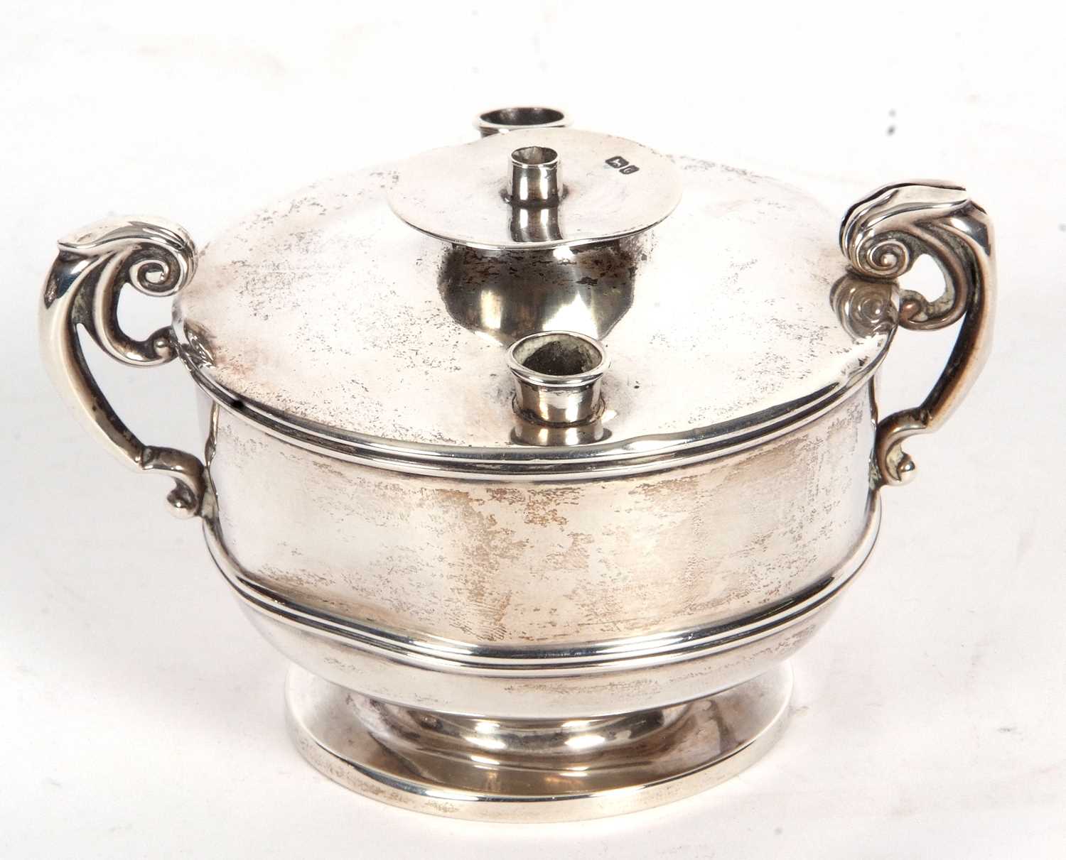 Edward VII officers mess table lighter of circular form, two hollow scrolled handles (misshapen,