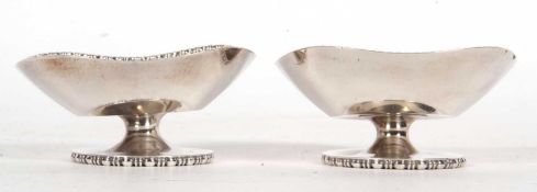 Pair of George V pedestal bon bon dishes of shaped square design with beaded rims and circular bases