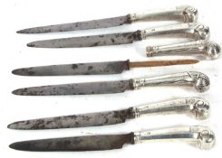 A set of six Georgian table knives with steel blades and silver pistol handles, each engraved with a