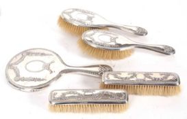Edwardian five piece silver backed dressing table set comprising hand mirror, two hairbrushes and