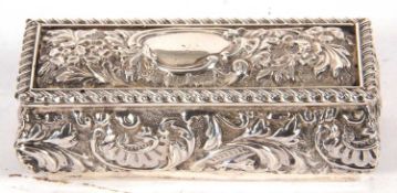 Edwardian silver trinket box of sarcophacus form, the hinged lid and sides embossed and chased
