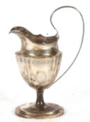 George V large pedestal milk jug in neo classical style of fluted oval form to a plain oval foot,