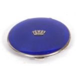 George V circular powder compact, the blue enamelled lid with crown insignia to the centre, engine