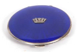 George V circular powder compact, the blue enamelled lid with crown insignia to the centre, engine