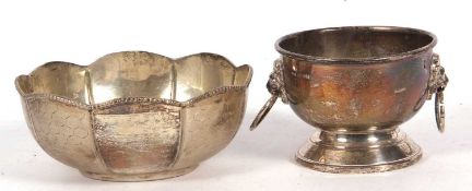 A small silver bowl in the form of a punch bowl applied with two lion heads grasping ring handles,