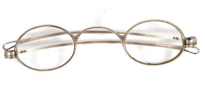 Cased pair of William IV silver framed spectacles with oval lenses, articulated side arms, London,