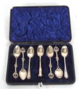 Case containing four matching Victorian import hallmarked teaspoons with cast handles and three