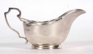 George V sauce boat of usual form with applied scrolled rim, scrolled handle, plain oval foot,