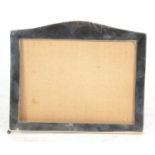 George V plain silver mounted photograph frame, rectangular shape with arched top, oak easel back,