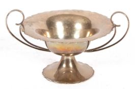 Edward VII silver twin handled sweetmeat dish having a round cut carved rim supported by two large