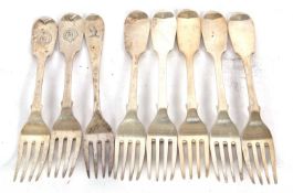 A group of eight Georgian and Victorian fiddle pattern dessert spoons including five hallmarked