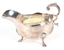 Victorian silver large sauce boat having a wavy rim, a canthus detail flying sea scroll handle,