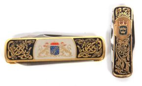 Two Swedish gilt metal an enamel case folding multi bladed pen knives, 7cm and 5.5cm (2)