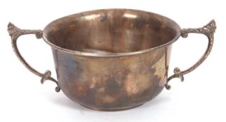 Georve V sugar bowl of circular form, the cast scrolled handles with acorn finial, 10cm diameter,