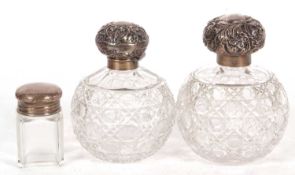 Large cut glass scent bottle of globular form with screw on silver embossed lid, hallmarked for