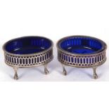 Pair of Victorian open salts of oval form, the pierced bodies with a vacant cartouche and a