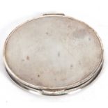 A large George VI circular powder compact with engine turned lid and base, mirror within, 10cm