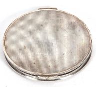 A large George VI circular powder compact with engine turned lid and base, mirror within, 10cm