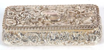 Edwardian silver trinket box of sarcophacus form, the size and hinged lid profusely embossed with