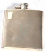 Art Deco silver hip flask of slight curved form, engine turned decoration and one side with a