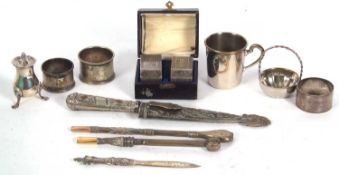Mixed lot to include a cased pair of George VI silver napkin rings, engine turned decorated, name