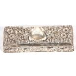 Edwardian silver hinged lid trinket box of rectangular form heavily embossed with flowers and