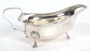 George V sauce boat of shaped triangular form with shell and gadrooned rim, angular handle and