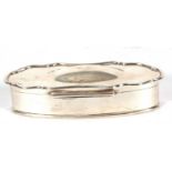 Edward VII silver trinket box of plain shaped oval form, the hinged lid with a domed centre, the