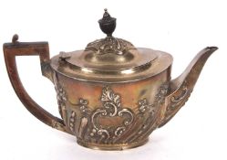 Late Victorian oval teapot with rithan fluted and floral embossed decoration, ebonised handle and