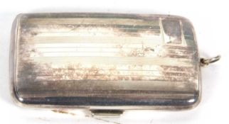 George V ladies cigarette case of curved rectangular form with banded engine turned decoration to