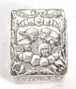 Modern white metal pill box, the hinged lid decorated with cherubs, 5 x 4 x 2 cm (unmarked) 30.2