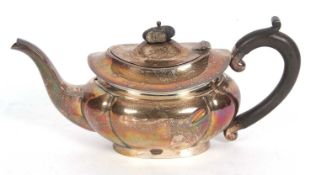 George V teapot of fluted and compressed oval form with spreading apron ebonised finial to the