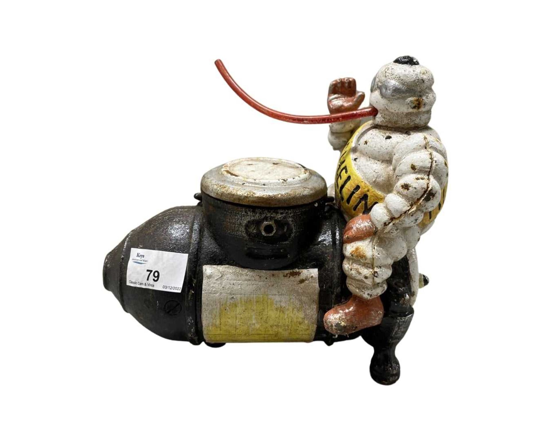 Cast iron Michelin Man riding a compressor