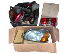 Three boxes of mixed car headlights and rear lights for various makes and models