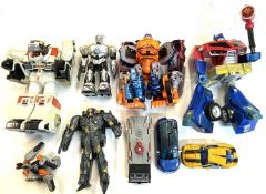 A mixed lot of retro plastic action figures to include:- Optimus Prime- Optimal Optimus: Ape Face-