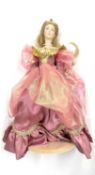 A 1987 Franklin Heirloom Dolls porcelain doll on stand, modelled as a princess in pink gown with