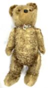 A vintage straw-stuffed teddy bear, no maker's label.