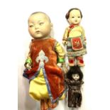 An Armand Marseille bisque Oriental boy doll, in colourful traditional clothing, marked 353/3 1/2K