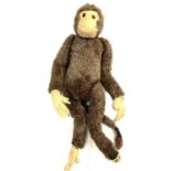 A cheeky vintage straw-stuffed monkey. Some repairs required.