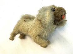 A vintage straw-stuffed dog. No makers mark, some repairs and in need of tlc.