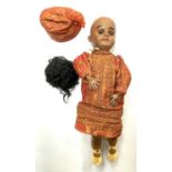 A Simon & Halbig bisque head doll, formed as an Indian girl with flirty eyes operated by a string at