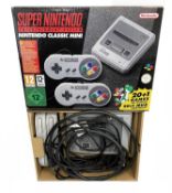 A boxed Super Nintendo Entertainment System (SNES): Nintendo Classic Mini, with 2 gamepads and 20