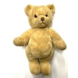 A modern Steiff teddy bear, with gold Steiff button and yellow label to ear.