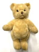 A modern Steiff teddy bear, with gold Steiff button and yellow label to ear.