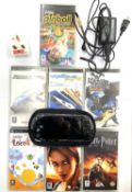 A 2005 PSP handheld console in original slipcase, with charging lead (US plug, but includes UK