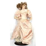 A Franklin Heirloom porcelain doll formed as a lady in pink gown with pearl-effect detail. Height