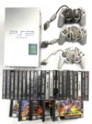 An unboxed Sony Playstation 2 console in silver, together with 2 offical controller pads, 1