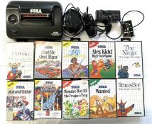 A 1990 Sega Master System II video game console and game pad in original box, to include several