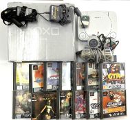 A boxed Sony Playstation PS1 console, with 2 game pads, leads, memory card and a quantity of games