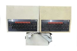 A pair of 1980s BBC microcomputers, one with Watford external disc reader, together with a